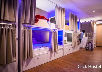 a room with a large fish tank with curtains at Click Hostel in Bangkok