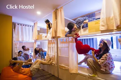 a group of people in a room with bunk beds at Click Hostel in Bangkok