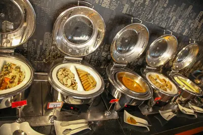 a bunch of plates of food on a counter at Le Fenix Sukhumvit 11 Bangkok in Bangkok