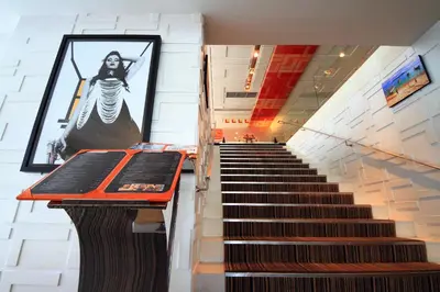 a staircase with a picture of a woman on the wall at Le Fenix Sukhumvit 11 Bangkok in Bangkok