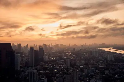 a view of a city with a cloudy sky at COMO Metropolitan Bangkok in Bangkok