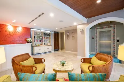 a living room with chairs and a table at La Petite Salil Sukhumvit 8 in Bangkok