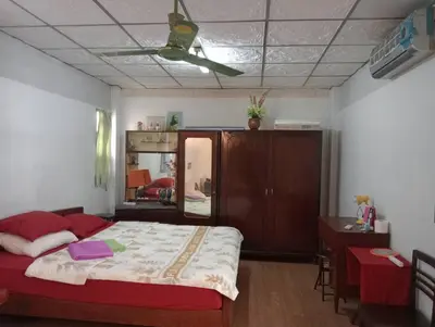 a bedroom with a bed and a desk and a mirror at Social Style Culture in Bangkok