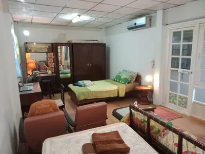 a room with a bedroom with a bed and a mirror at Social Style Culture in Bangkok