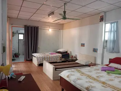 a hotel room with two beds and a table at Social Style Culture in Bangkok