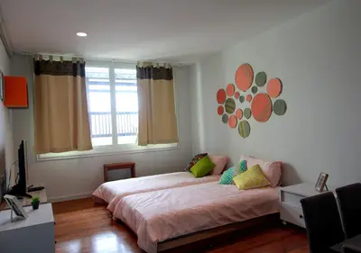 a bedroom with a large bed and a window at The Serene House Bangkok in Bangkok