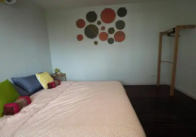 a bedroom with a large bed in a room at The Serene House Bangkok in Bangkok