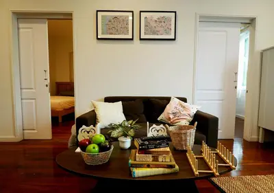 a living room with a couch and a coffee table at The Serene House Bangkok in Bangkok