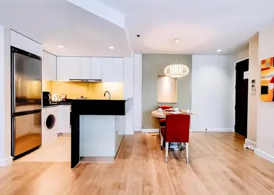 a kitchen with a table and a dining room at Urbana Langsuan Hotel in Bangkok