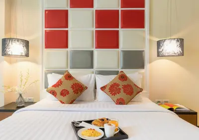 a tray of food sitting on top of a bed at FuramaXclusive Asoke, Bangkok in Bangkok