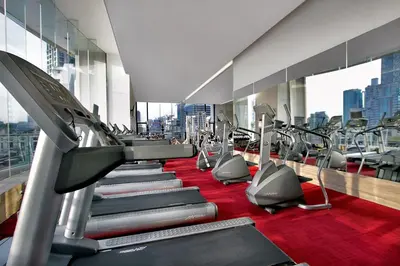 a gym with a row of treadmills at Somerset Park Suanplu Bangkok in Bangkok