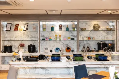 a kitchen with a counter with pots and pans at Club Mahindra Mac Boutique Hotel in Bangkok
