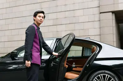 a man is getting out of a car at Crowne Plaza Bangkok Lumpini Park by IHG in Bangkok