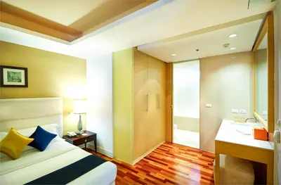 a hotel room with a bed and a bathroom at The Duchess Hotel in Bangkok