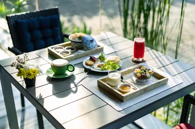 a table with plates of breakfast food on it at TUI BLUE Maduzi Hotel Bangkok in Bangkok