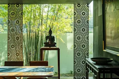 a statue sitting on a table in front of a window at TUI BLUE Maduzi Hotel Bangkok in Bangkok