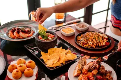 a table topped with plates of food on a table at Rembrandt Hotel Bangkok in Bangkok