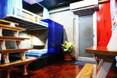 a room with two bunk beds and a window at DDM House in Bangkok