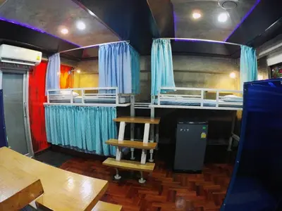 a room with two bunk beds and a table at DDM House in Bangkok