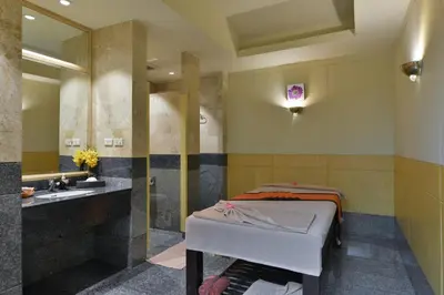 a bathroom with a sink and a bath tub at Miracle Grand Convention Hotel in Bangkok