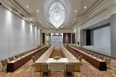 a large banquet hall with tables and chairs at Miracle Grand Convention Hotel in Bangkok
