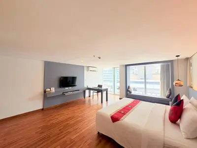 a bedroom with a large bed and a television at I Residence Hotel Silom in Bangkok