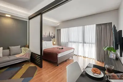 a hotel room with a bed and a couch at Citadines Sukhumvit 11 Bangkok in Bangkok