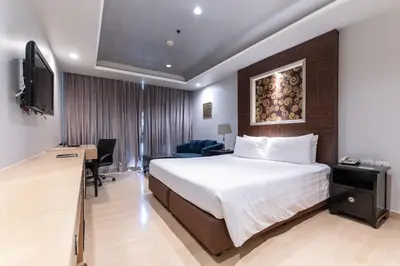 a hotel room with a bed and a television at Admiral Premier Bangkok in Bangkok