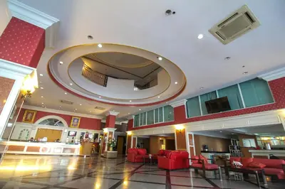 a large lobby with red chairs and a large mirror at Convenient Park Bangkok in Bangkok