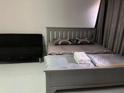 a bed with two pillows on it in a room at Popular Condo by Jintana in Pak Kret