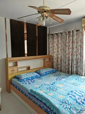 a bedroom with a bed and a ceiling fan at Popular Condo by Jintana in Pak Kret
