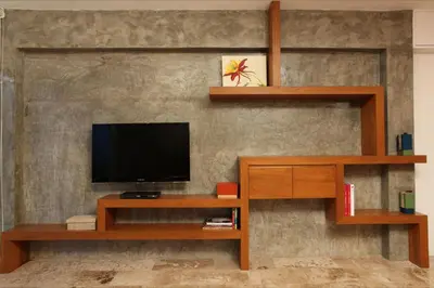 a living room with a television on a wall at Baannueng at Aree 5 Hotel in Bangkok