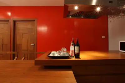 two bottles of wine sitting on a wooden table at Baannueng at Aree 5 Hotel in Bangkok