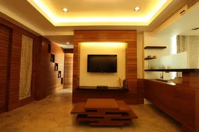 a living room with a flat screen tv on a wall at Baannueng at Aree 5 Hotel in Bangkok