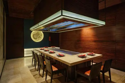 a dining room with a long table and chairs at JW Marriott Hotel Bangkok in Bangkok