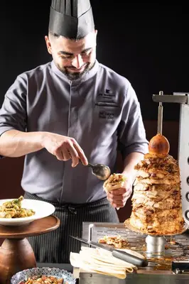 a chef is preparing a dish on a table at JW Marriott Hotel Bangkok in Bangkok