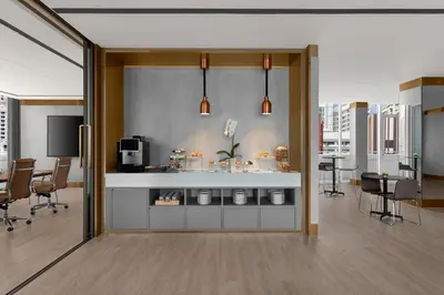 an open door to a room with a table and chairs at Courtyard by Marriott Bangkok in Bangkok
