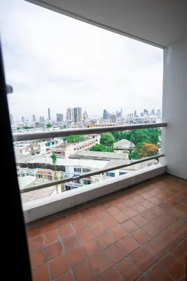a balcony with a view of a city at Chatrium Sathon Bangkok in Bangkok
