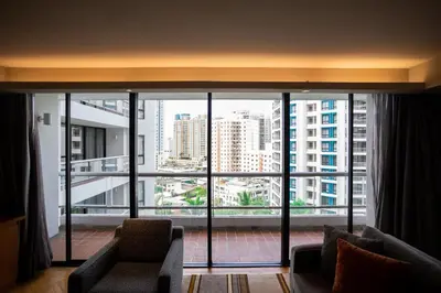 a room with a large window with a view of a city at Chatrium Sathon Bangkok in Bangkok