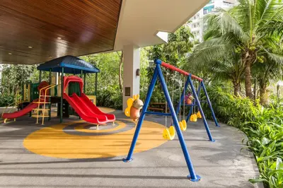 a playground with a slide and a swing at Chatrium Sathon Bangkok in Bangkok