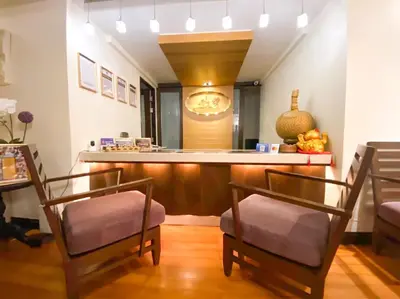a room with two chairs and a counter with a bar at The Quarter Saladaeng by UHG in Bangkok