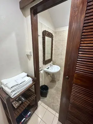 a bathroom with a sink and a mirror at The Siam Heritage Hotel in Bangkok