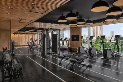 a gym with a lot of treadmills and weights at Millennium Hilton Bangkok in Bangkok
