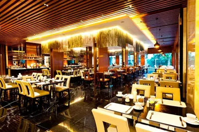 a restaurant with tables and chairs and a bar at Royal Princess Larn Luang - SHA Extra Plus in Bangkok