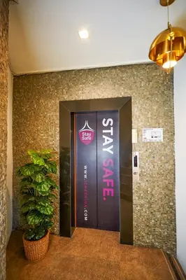 a door in a building with a sign on it at Studio Asoke in Bangkok