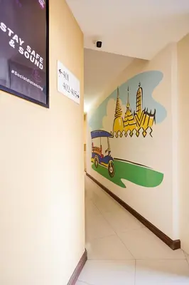 a hallway with a painting on the wall in a building at Studio Asoke in Bangkok