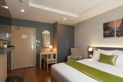 a bedroom with a bed and a table and a chair at iCheck inn Residence soi 2 in Bangkok