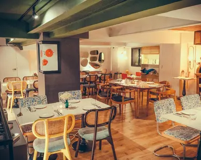 a dining room with tables and chairs in a restaurant at Sacha's Hotel Uno in Bangkok
