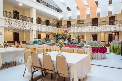 a banquet hall with white tables and chairs at Metro Point Bangkok in Bangkok