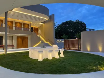 a white table in the yard of a house at Metro Point Bangkok in Bangkok